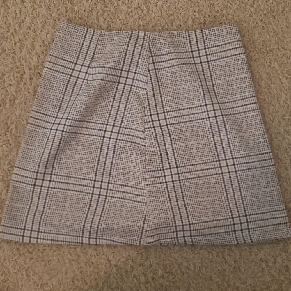 A plaid skirt from cotton on above knee.